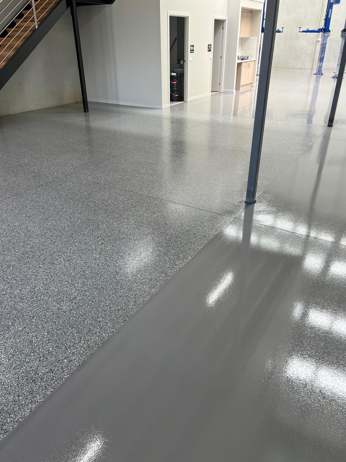 Silver flake and grey epoxy zones in a warehouse with a mezzanine