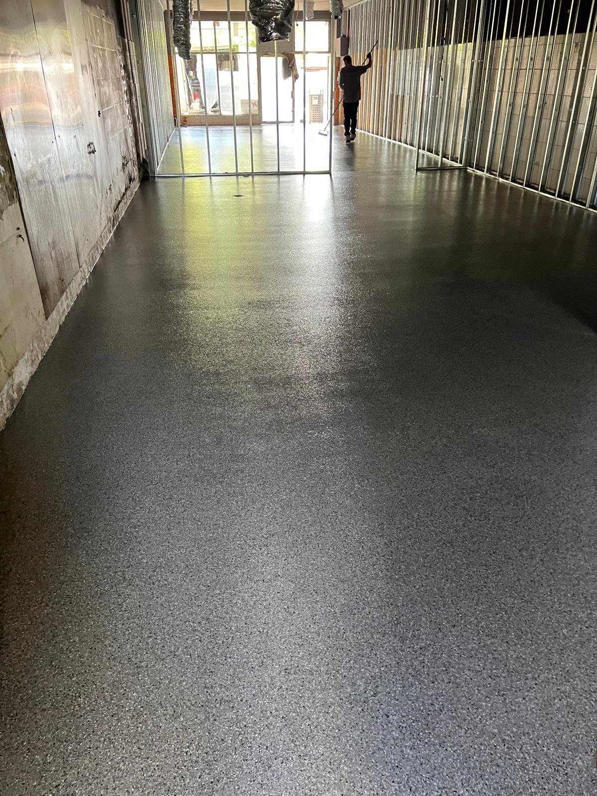 Dark charcoal epoxy flake floor in a bakery fit-out